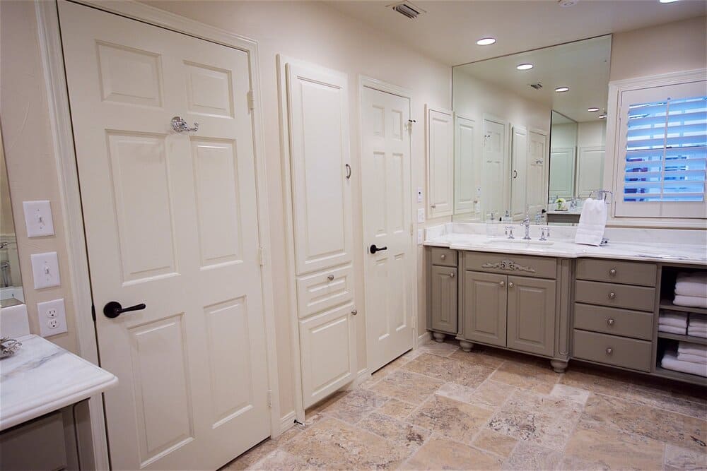 White Door to Bathroom with Giant Mirror Over Sink